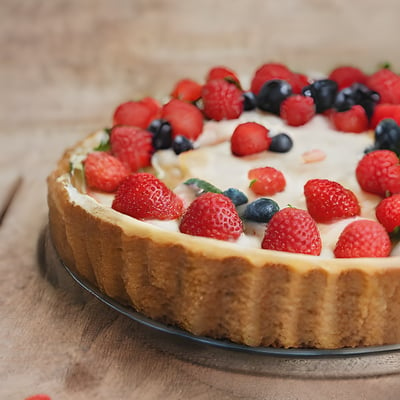 A cheesecake topped with berries and blueberries