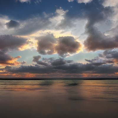 The sky is filled with clouds over the water