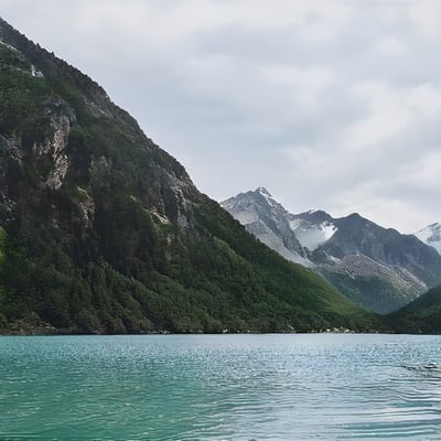 A body of water with mountains in the background