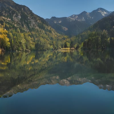 A lake surrounded by mountains in the middle of a forest