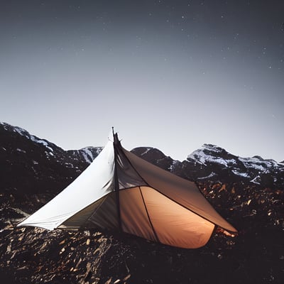 A tent pitched up on top of a rocky mountain