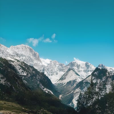 A view of a mountain range with snow on it