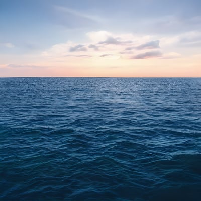 A body of water with a sky in the background