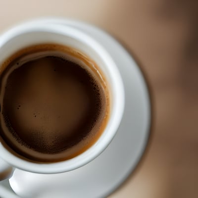 A close up of a cup of coffee on a saucer