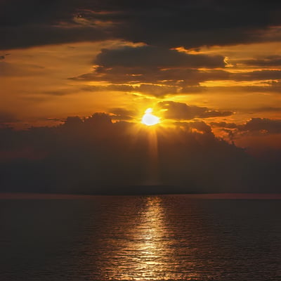 A large body of water with a sunset in the background