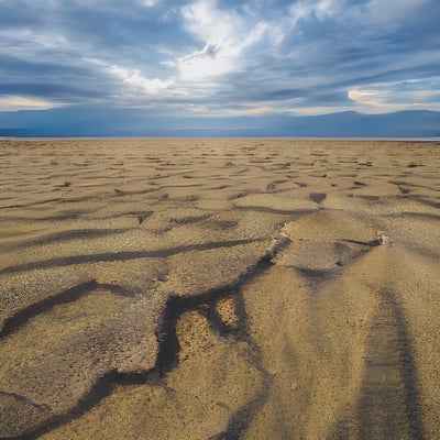 A sandy area with a blue sky in the background