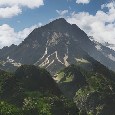 A very tall mountain with a lot of trees on top of it