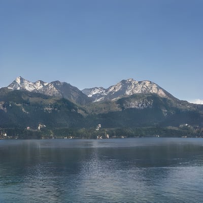 A lake with mountains in the background