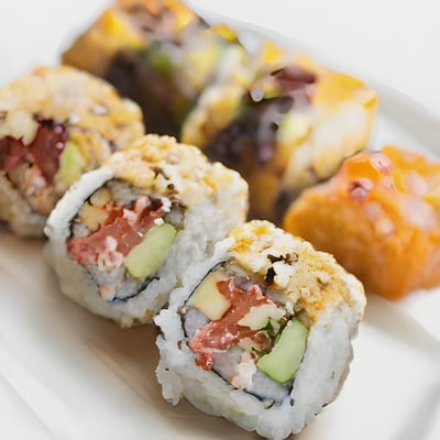 A white plate topped with sushi and rolls