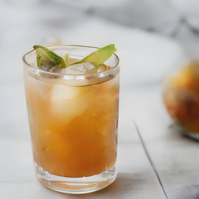 A close up of a drink in a glass on a table