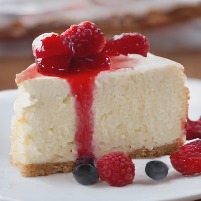 A piece of cheesecake with berries on a plate