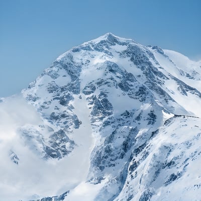 A skier is skiing down a snowy mountain