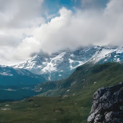 A view of a mountain range with snow on the top