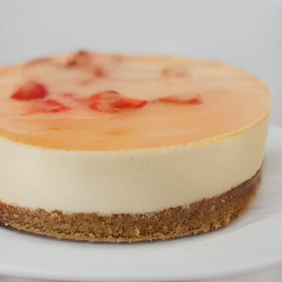 A cheesecake on a white plate on a table