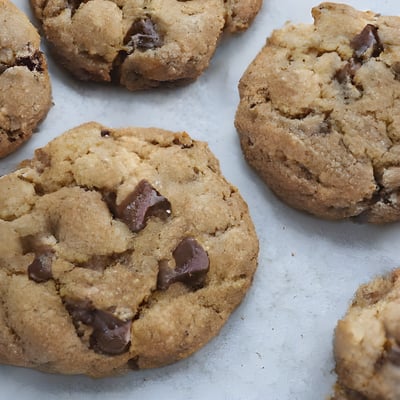 A close up of chocolate chip cookies on a table