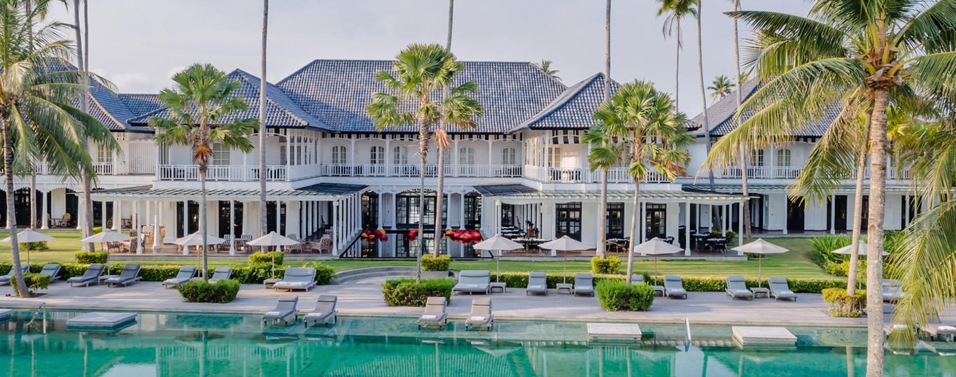 A pool in front of a houseDescription automatically generated