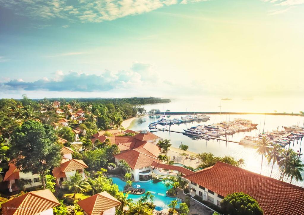 A group of houses next to a body of waterDescription automatically generated