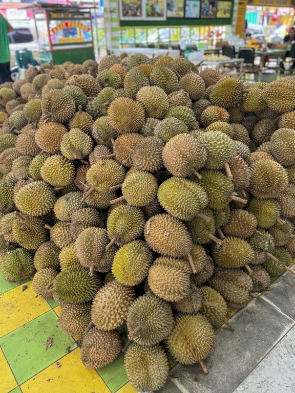 A pile of durian fruitsDescription automatically generated