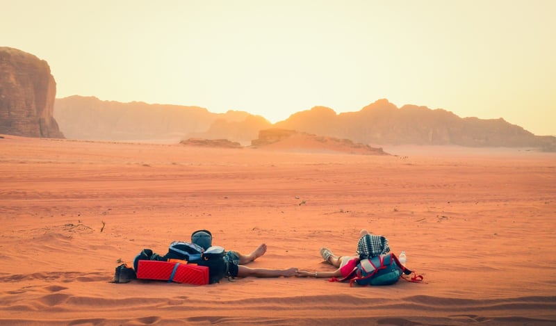 Tourists Laying Down In Wadi Rum