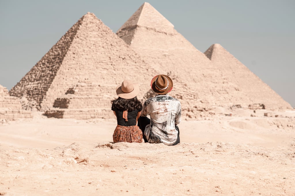 man and woman visiting the pyramids of giza