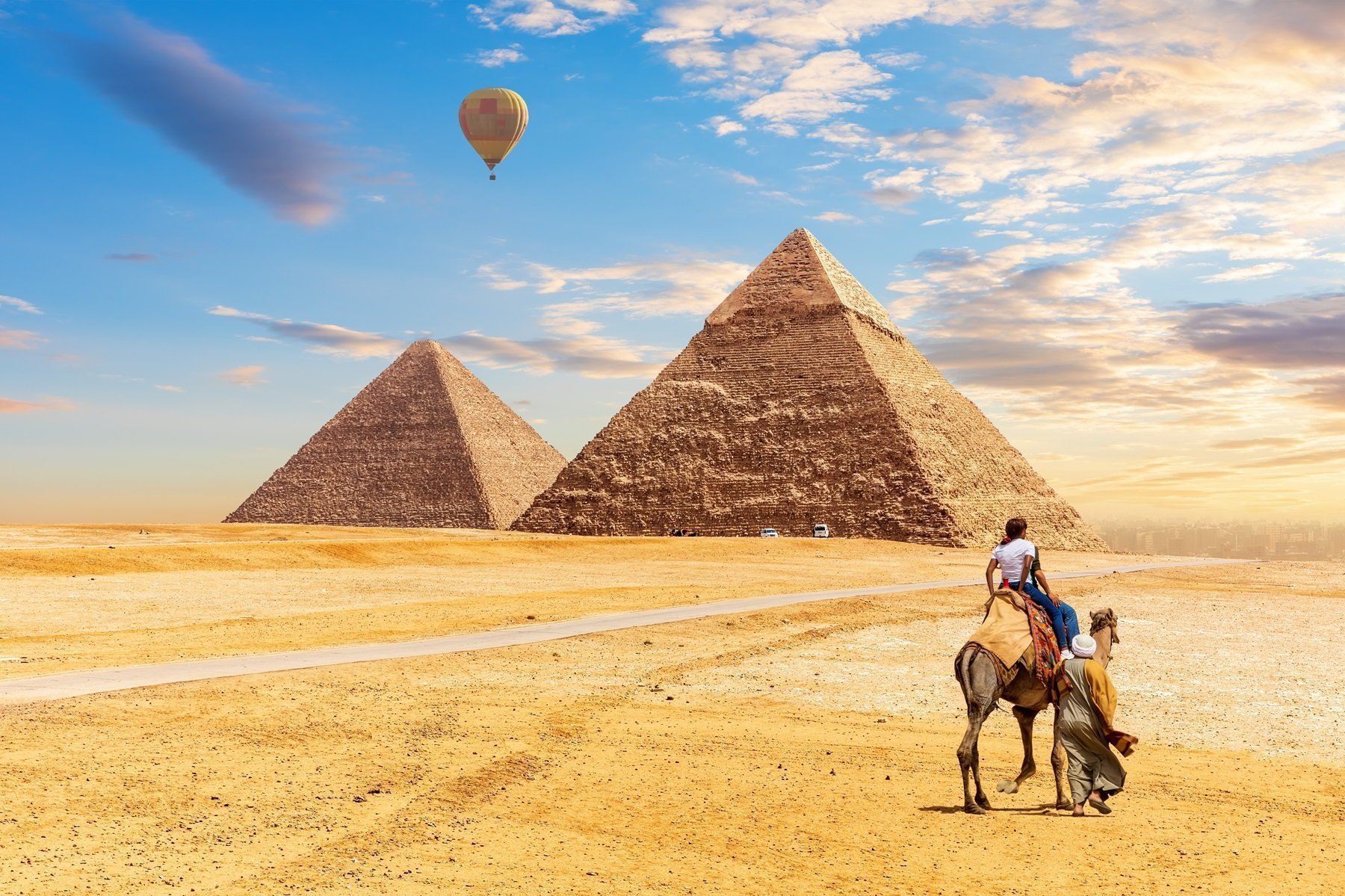 Tourist On Camel In Front Of The Pyramids Of Giza