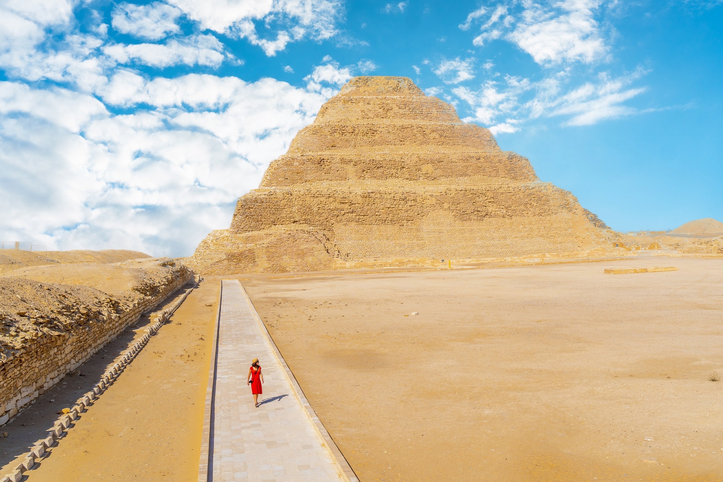 A Young Tourist In A Red Dress In Front Of Saqqara