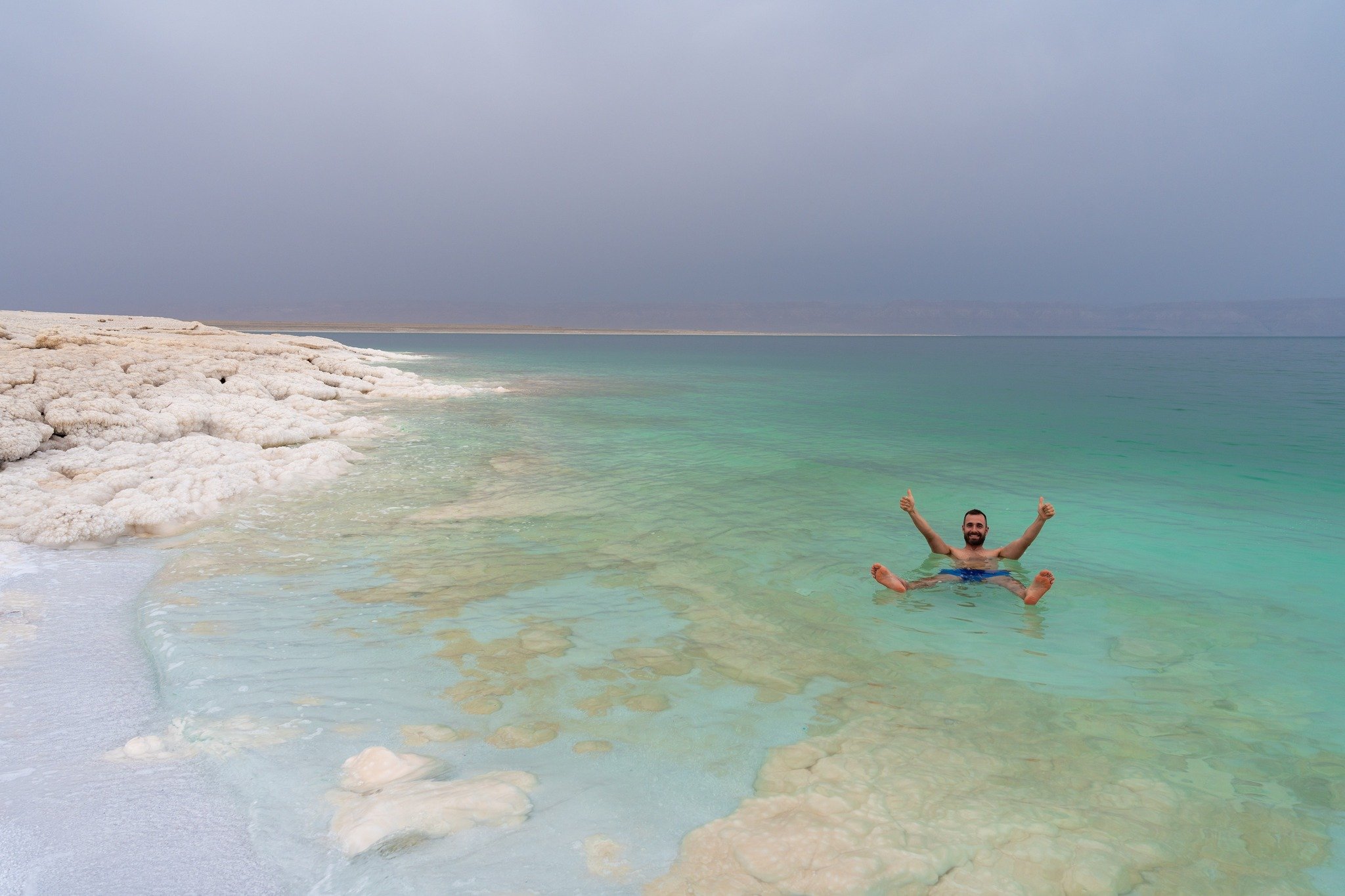Tourist Floating In The Dead Sea Jordan