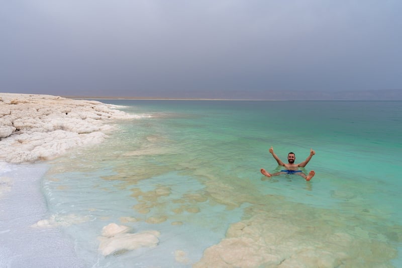 Tourist Floating In The Dead Sea Jordan
