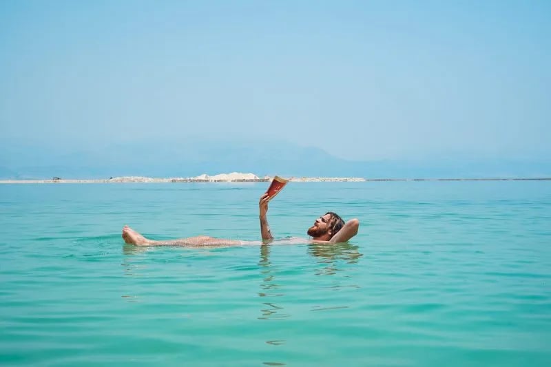 Tourist Floating In The Dead Sea Israel