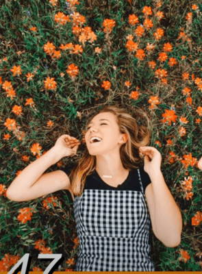 Girl laughing near tree