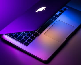MacBook with colorful neon lighting on keyboard and screen