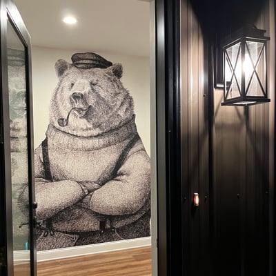 one of the house entrances with a bear as a captain decal on the wall