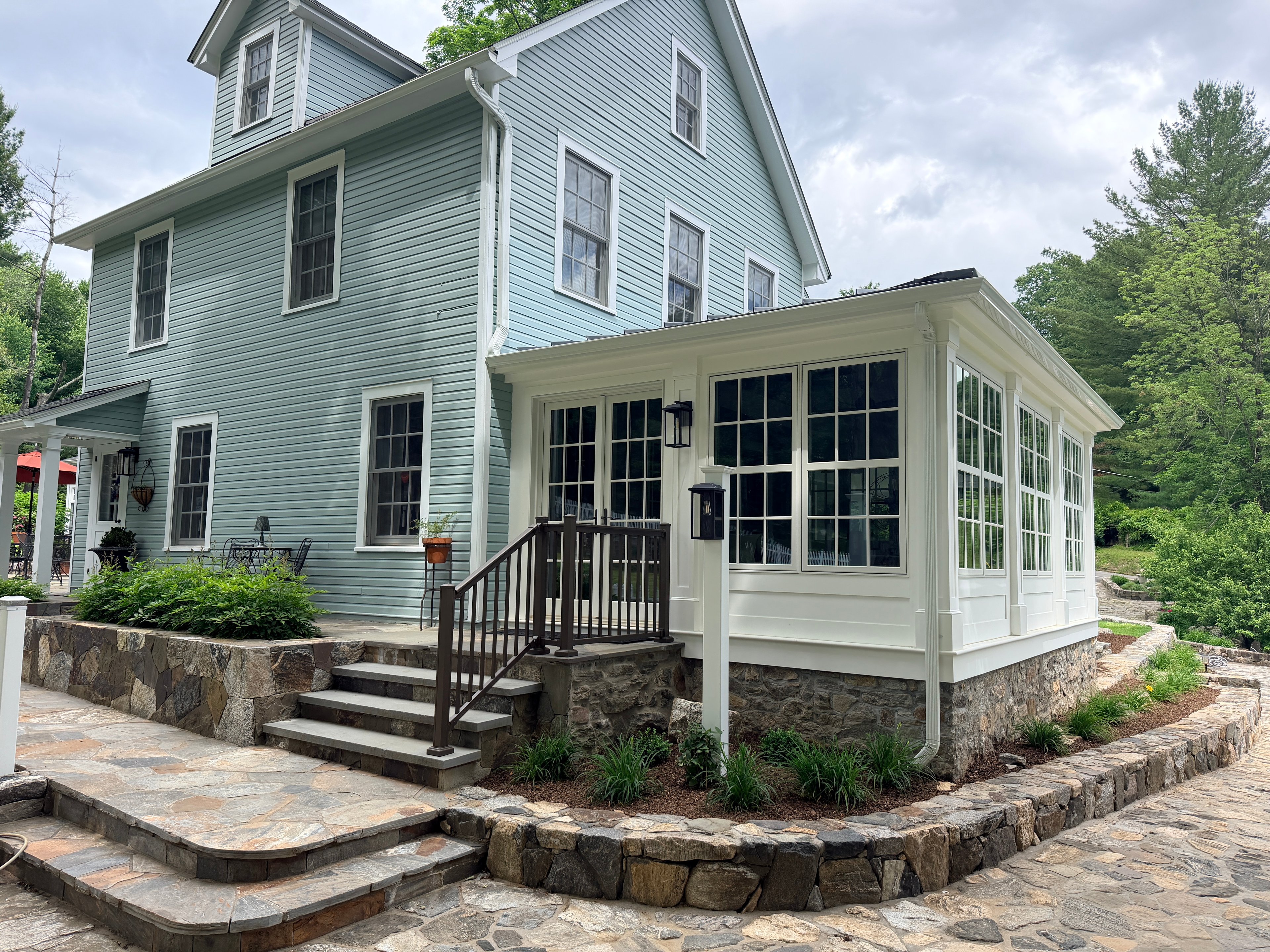 Somers sunroom — exterior with stone patio and entry steps