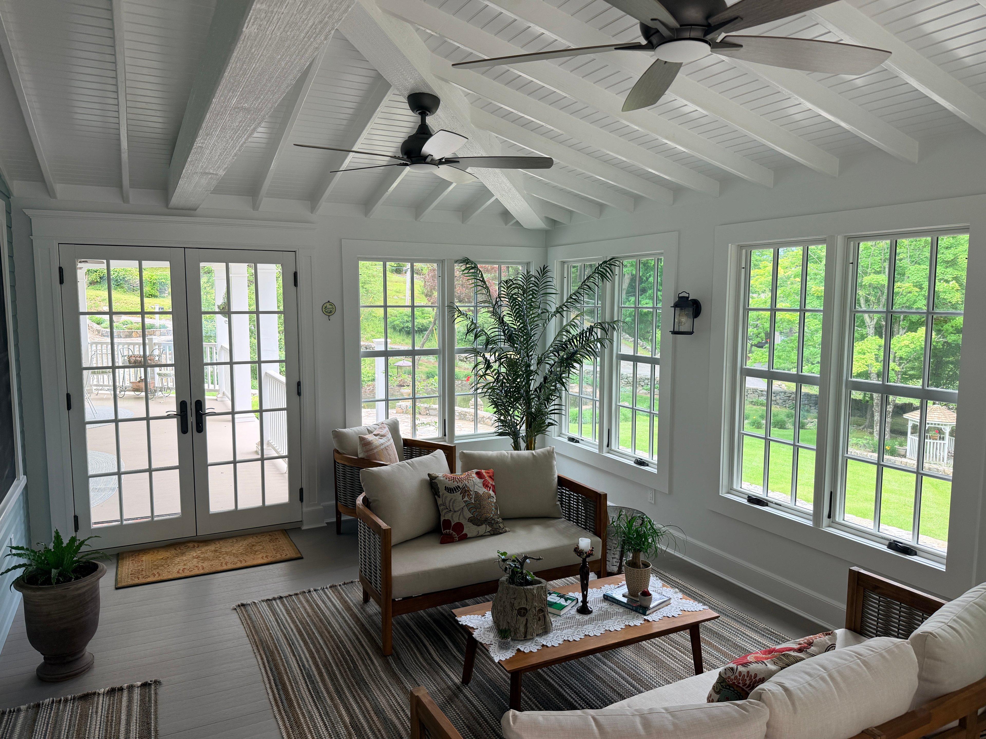 Somers sunroom — vaulted beadboard ceiling with exposed beams and dual ceiling fans