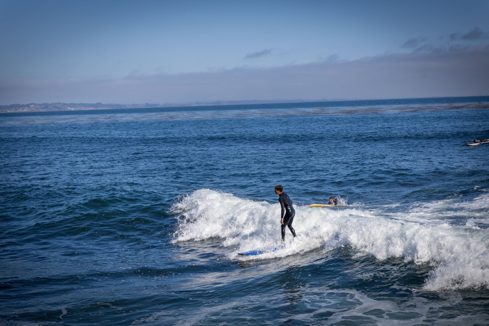 A surfer riding a breaking wave at Pleasure Point.