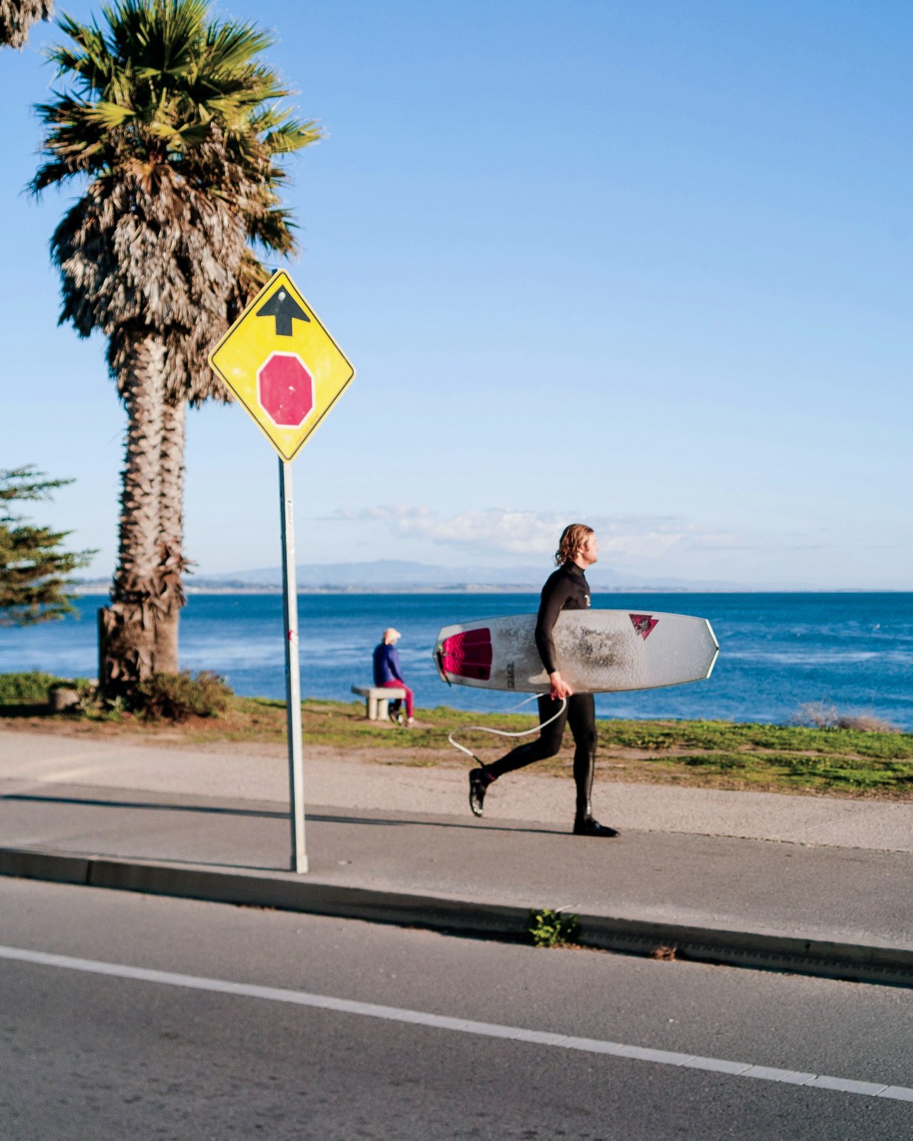 Surfer walking the bluffs at Pleasure Point, Santa Cruz