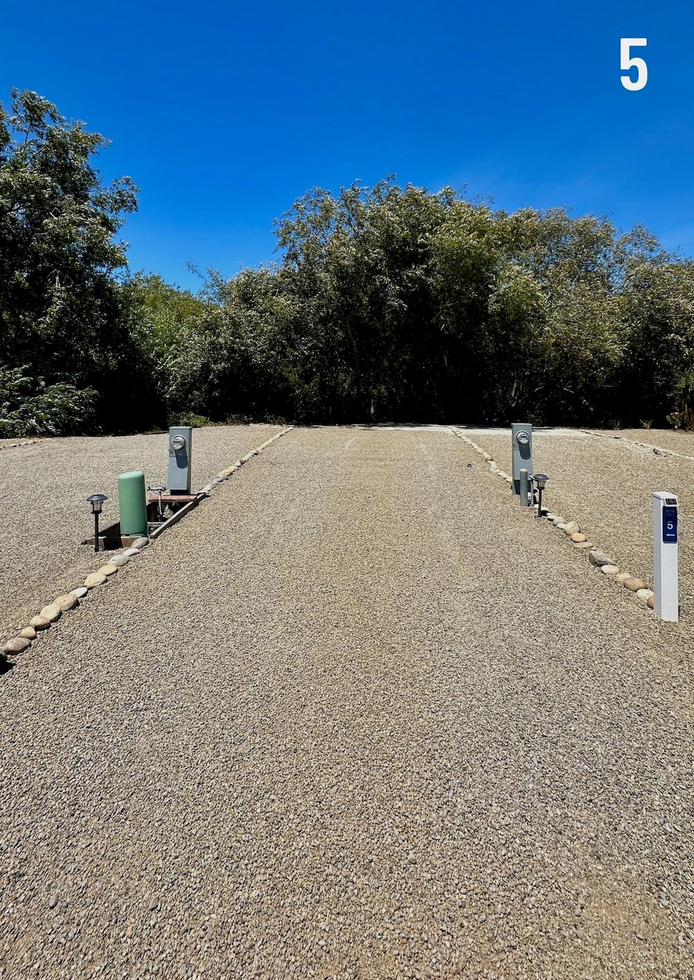 Empty Longboard site 5, a 60-foot level gravel pad backing onto Rodeo Creek