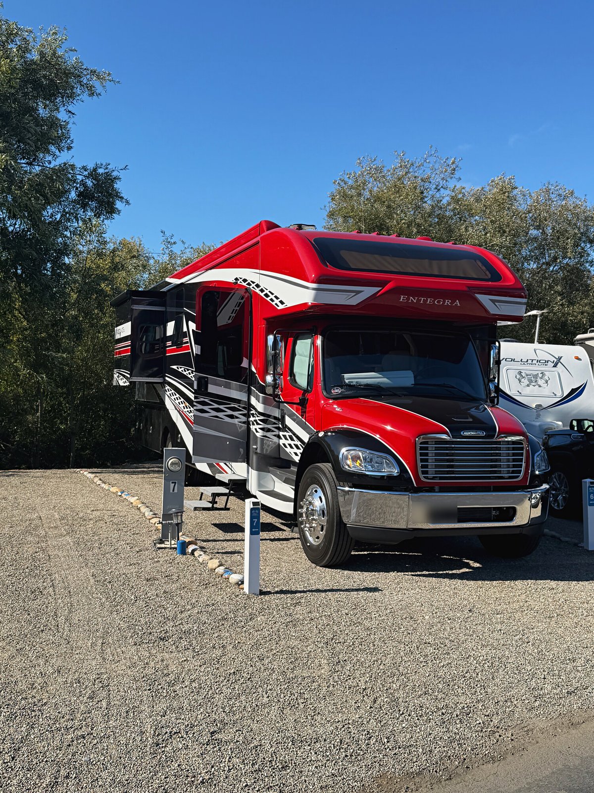 Red Super C motorhome parked on a 60-foot Longboard pull-in site in Santa Cruz