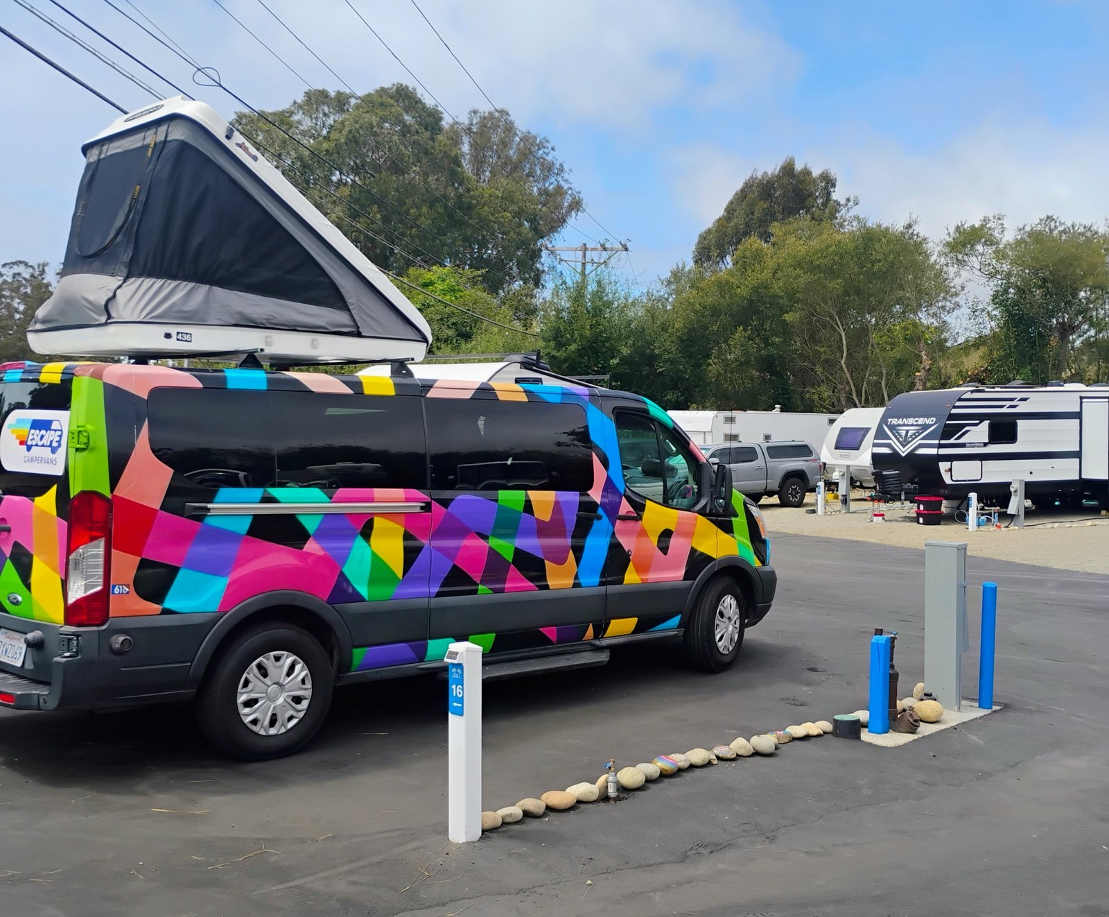 Brightly painted pop-top campervan on a Snug site at Beach RV Pleasure Point