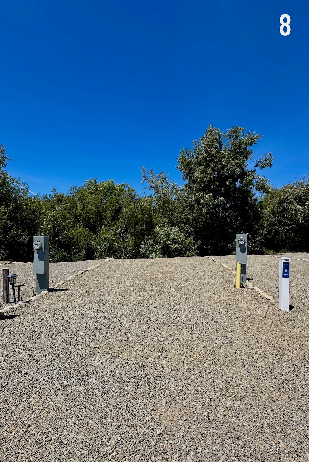 Empty Standard site 8, a level gravel pad set against Rodeo Creek