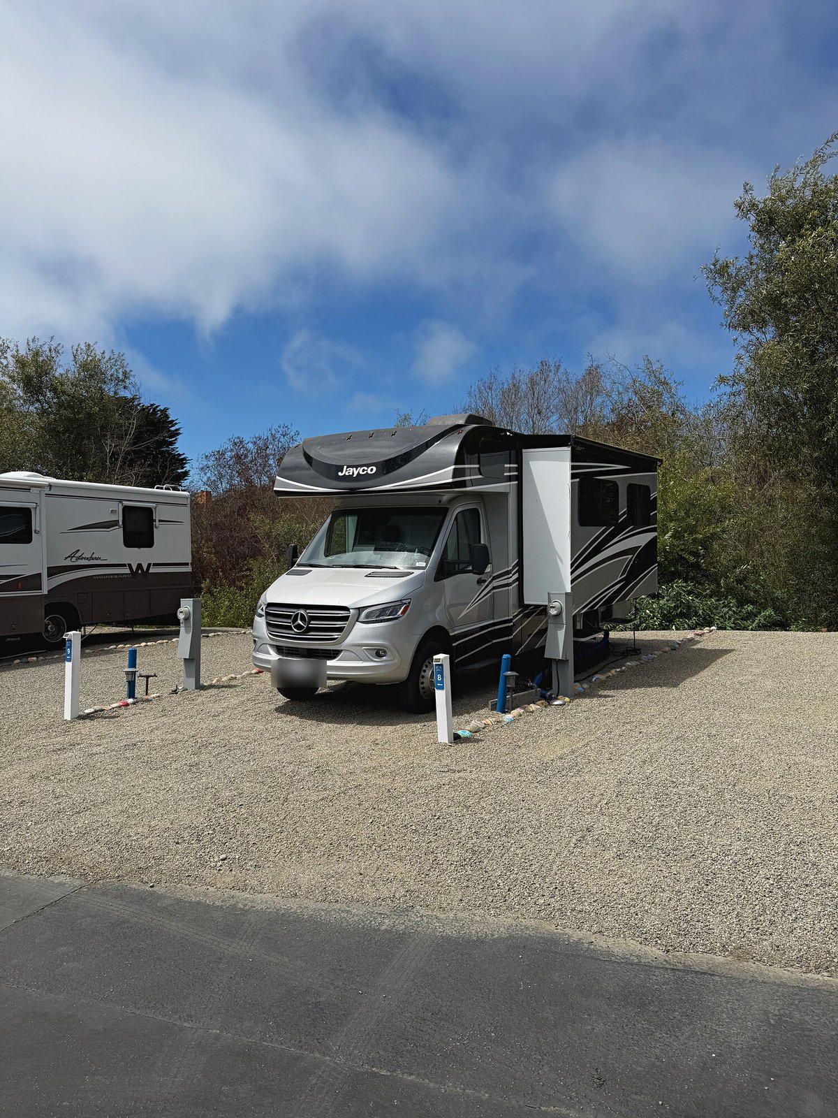 Jayco motorhome with its slide-out extended on a Standard site