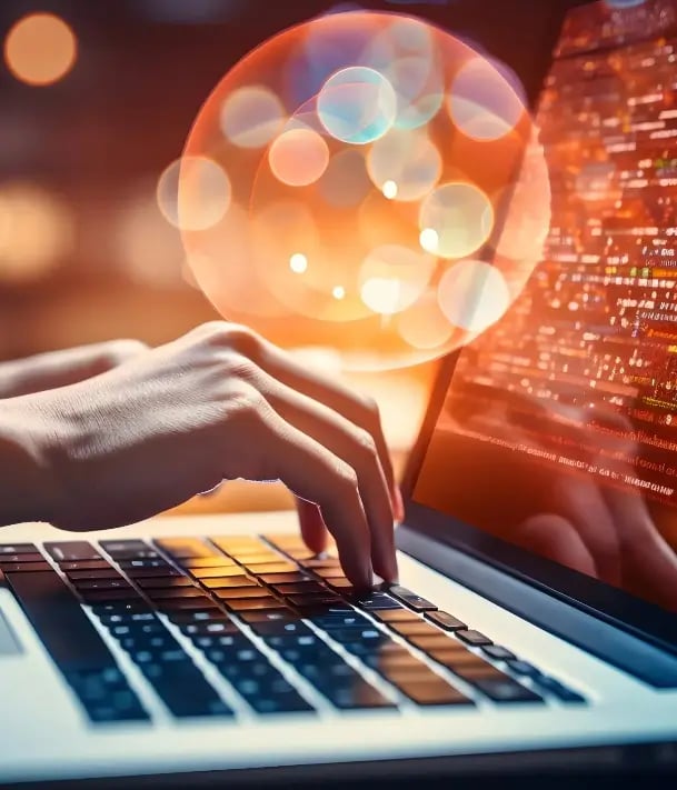 Person working on laptop with glowing SEO icons and code, symbolizing search engine optimization and digital strategy