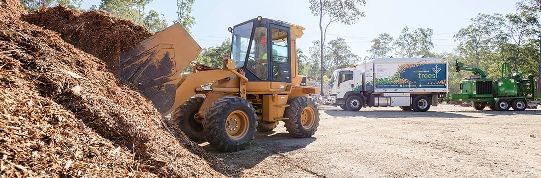 Loader working a pile of aged forest mulch at the Samford yard