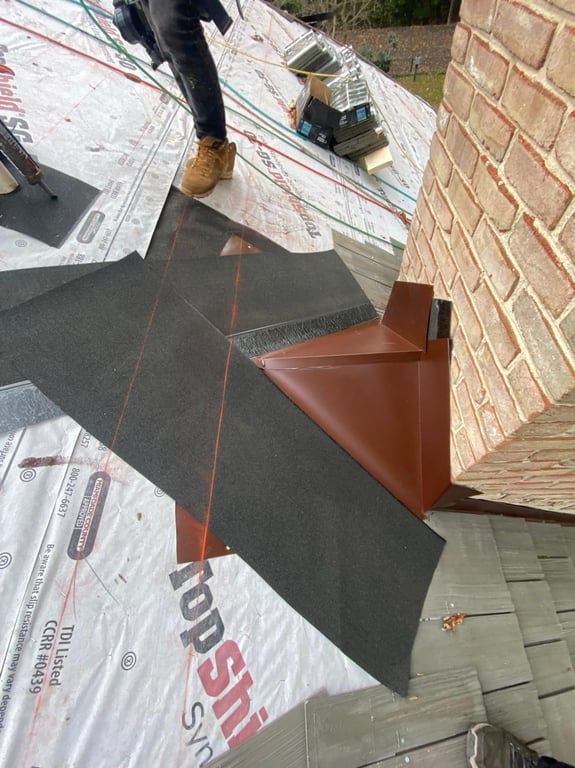 A person standing on a roof

Description automatically generated