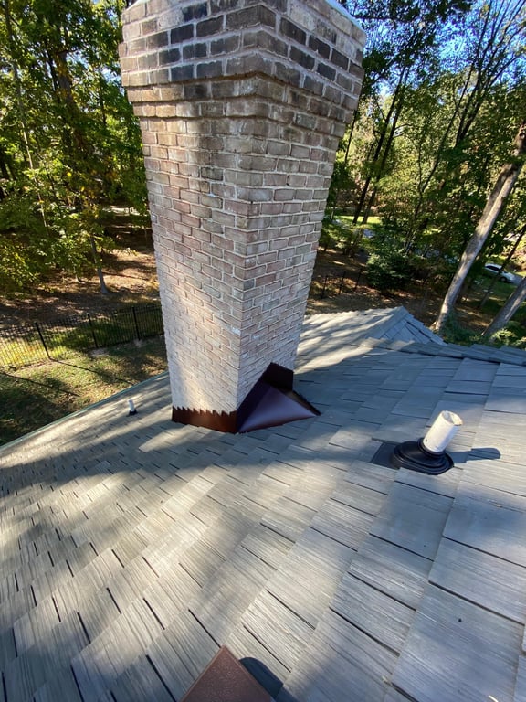 A chimney on a roof

Description automatically generated