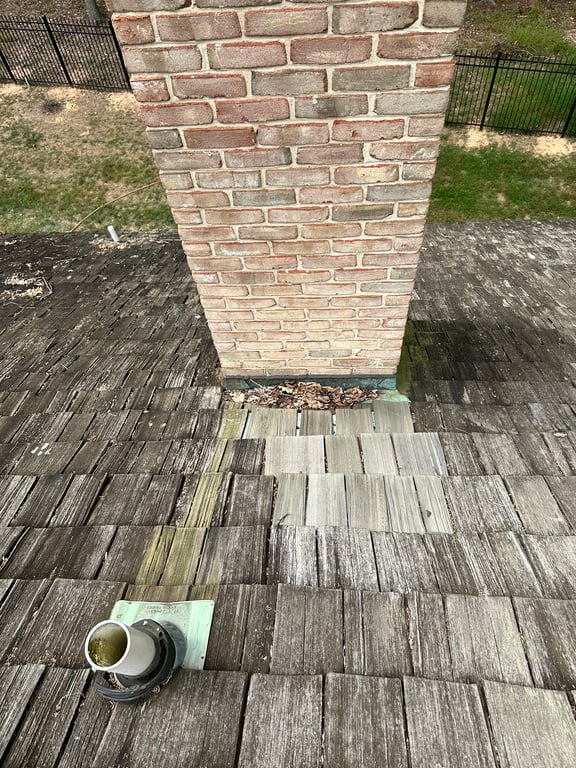 A chimney on a roof

Description automatically generated