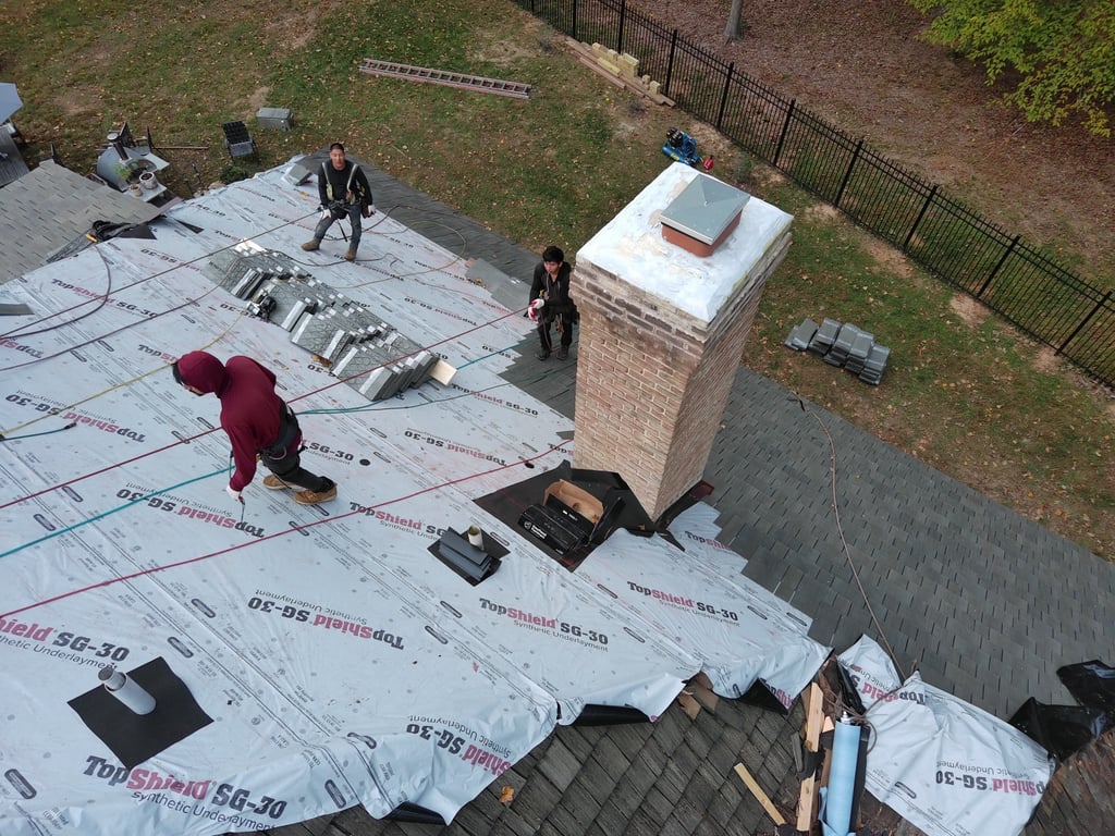 A roof with a chimney being repaired

Description automatically generated with medium confidence