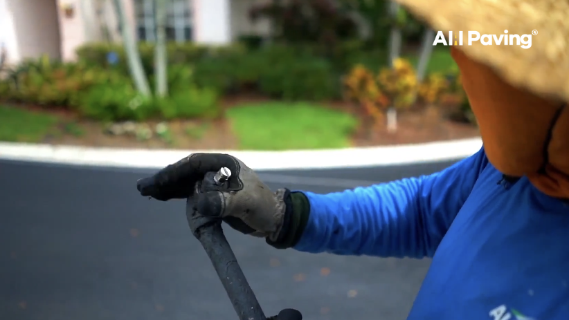 Close-up of sealcoating nozzle and hose used for professional asphalt application