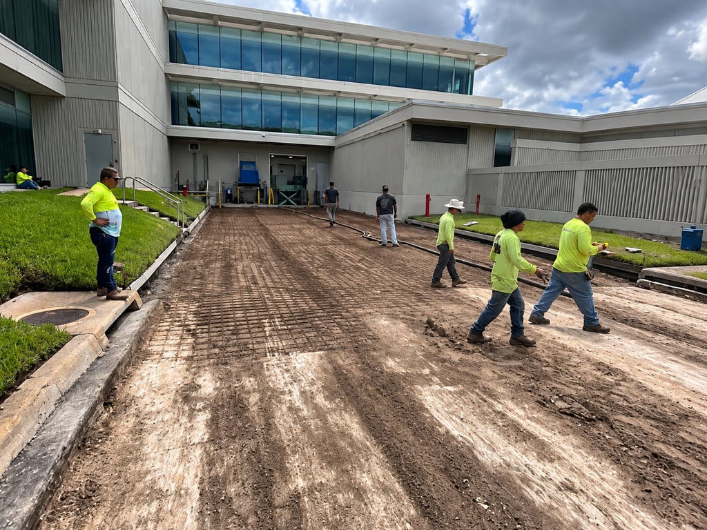 Crew grading and leveling a parking area base at a Florida commercial building