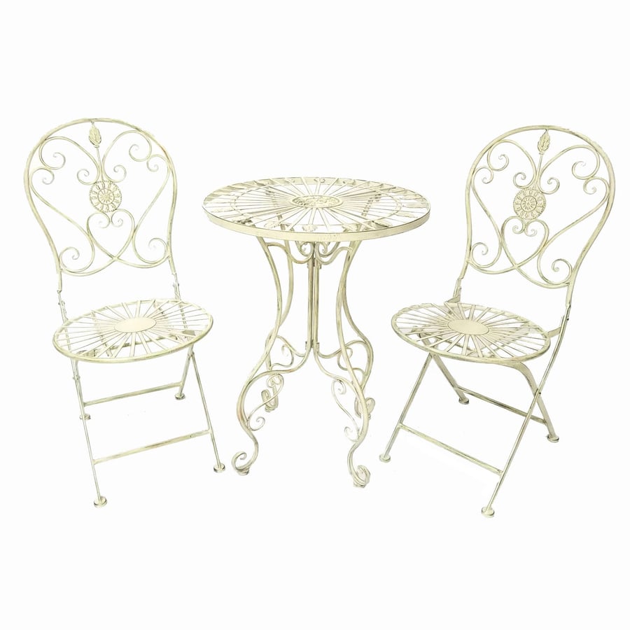 Blaydon antiqued black metal folding bistro set in a UK cottage garden with foxgloves